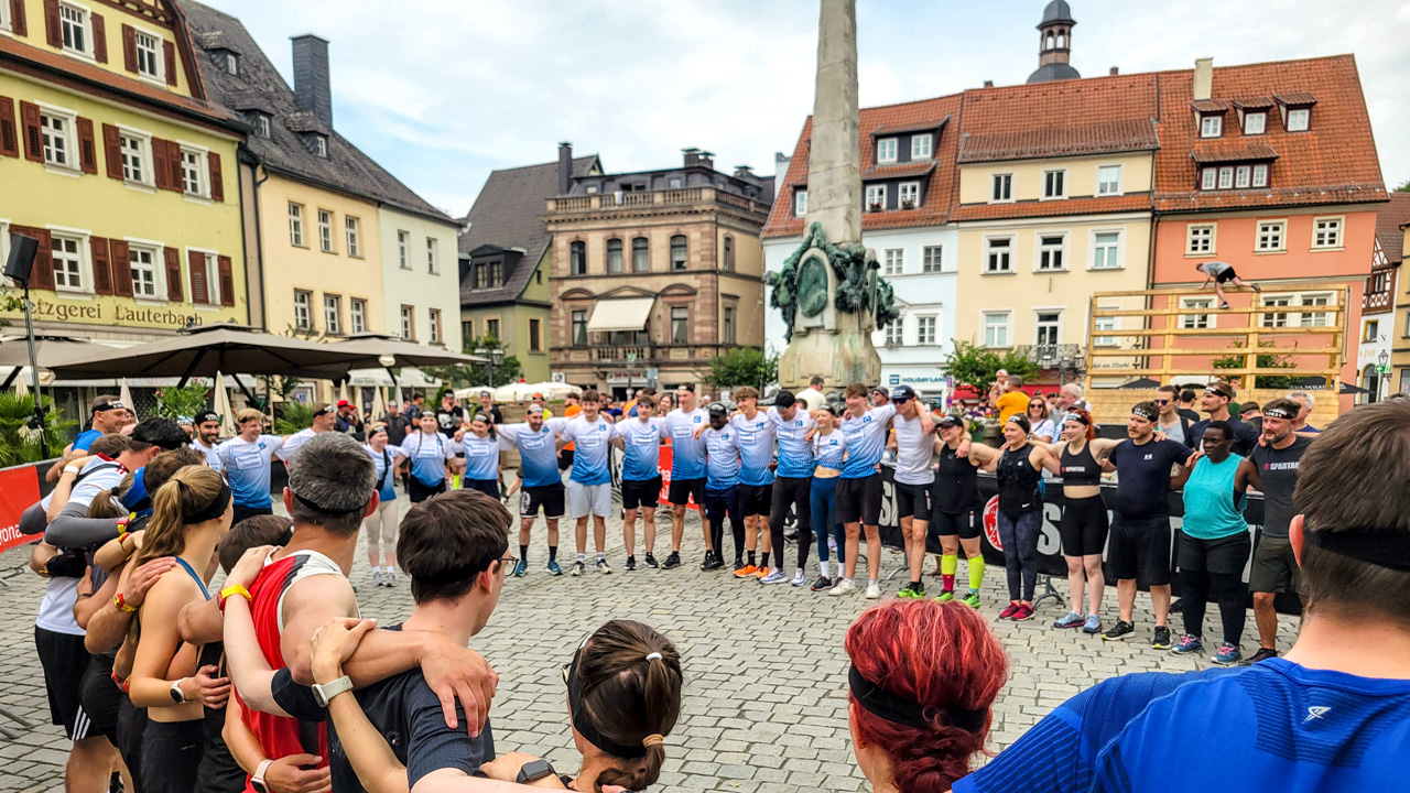 Sportler stehen im großen Kreis gemeinsam, um sich auf das anspruchsvolle Rennen vorzubereiten.